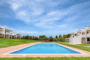 an image of a swimming pool in front of houses at Dream 2BDR Apartment W/Pool by LovelyStay in Alvor