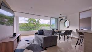 a living room with a couch and a table at Stunning, Brand-new Apartment in Santa Fe de Antioquia