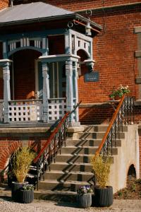 a brick building with stairs in front of a building at Aggershøj pensionat in Marstal