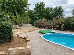 a small swimming pool in a yard with a garden at Il Casolare Degli Ulivi in Oria