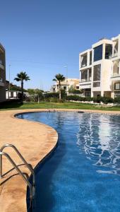 a swimming pool in front of a building at RAWAN RESIDENCY in Oujda