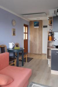 a living room with a table and a kitchen at Apartment Pr Dev in Begunje na Gorenjskem