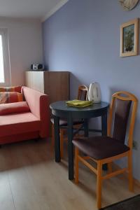 a living room with a table and a chair at Apartment Pr Dev in Begunje na Gorenjskem