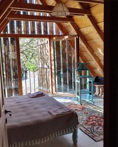 a bedroom with a bed in a wooden house at Verde de Viscri in Viscri