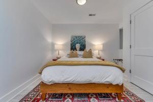 a bedroom with a large bed with two lamps at Charming 2BD in Hip Neighborhood - 3 Blks to Metro in Washington, D.C.