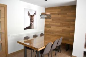 a dining room with a table and a donkey picture on the wall at Apartamento Tubal in Bossost +7 photos