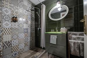 a bathroom with a sink and a mirror at Orpheus and Eurydice Boutique Apartments in Skiathos