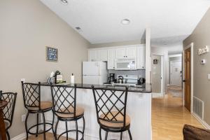a kitchen with bar stools and a counter top at Beachside 329 Waterfront Condo in Traverse City