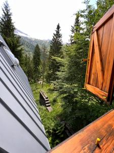 a door on a house with a view of a forest at ~Chalet_Rifugio tra i boschi~ in Sella Nevea