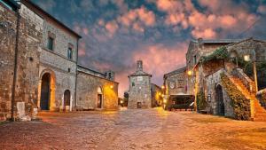an empty street in an old building with a cloudy sky at La Dolce Sosta in Catabbio