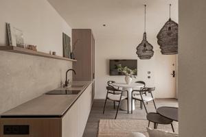 a kitchen and dining room with a table and chairs at Hill Palanga & SPA in Palanga