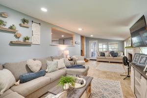a living room with a couch and a tv at Frostproof Lakefront Home with Screened-In Porches! in Frostproof
