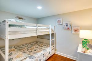 a bedroom with two bunk beds and a desk at Frostproof Lakefront Home with Screened-In Porches! in Frostproof
