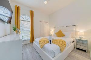 a white bedroom with a bed and a window at 596 Modern 5 bed home overlooking beautiful golf course and conservation with Games room in Davenport +68 photos