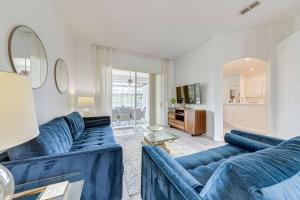 a living room with two blue couches and a table at 596 Modern 5 bed home overlooking beautiful golf course and conservation with Games room in Davenport