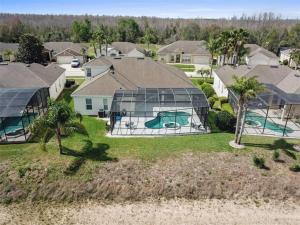 an aerial view of a home with a glass house at 596 Modern 5 bed home overlooking beautiful golf course and conservation with Games room in Davenport