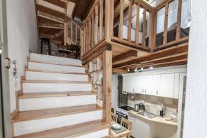 a kitchen with stairs in a tiny house at Cicones Boutique Apartments in Skiathos