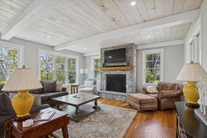 a living room with a fireplace and a tv at Francis Lane in Stowe