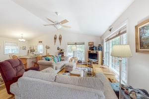 a living room with two couches and a table at The Winkumpaugh Getaway in Ellsworth