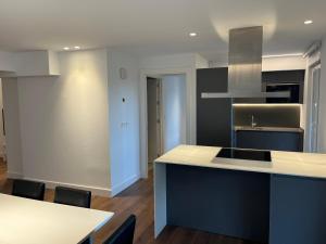 a kitchen with a counter and a table and chairs at Ederra By Basquelidays in Irún