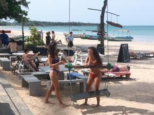 two girls in bathing suits on the beach at BEACH LIFE UPPUVELI in Trincomalee