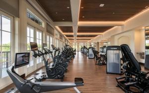 a gym with a row of treadmills and exercise bikes at Camp Creek Inn in Seacrest