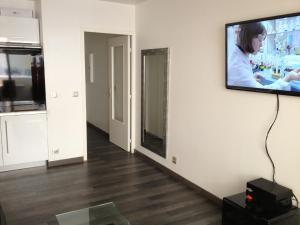 a living room with a flat screen tv on a wall at Juana in Antibes
