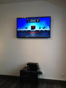 a flat screen tv hanging on a white wall at Juana in Antibes