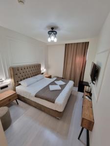 a bedroom with a large bed and a television at Elite Park Hotel & Suites in Beylikduzu