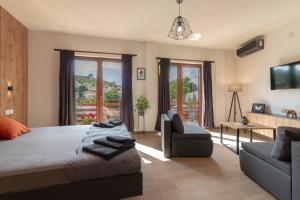 a bedroom with a large bed and a living room at City Gate Apartment in Ohrid
