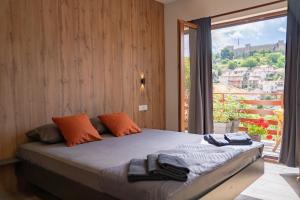 a bedroom with a bed and a large window at City Gate Apartment in Ohrid