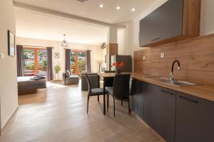 a kitchen with a sink and a table with chairs at City Gate Apartment in Ohrid