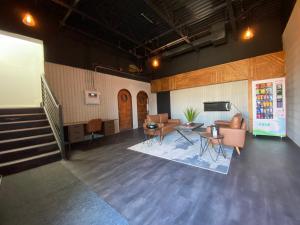 a large room with chairs and tables and a staircase at RNDup Urban Lofts in Clairmont