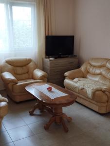 a living room with two couches and a coffee table at Dobra Voda YSV in Dobra Voda