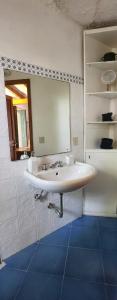 ein Badezimmer mit einem weißen Waschbecken und einem Spiegel in der Unterkunft Villa Chiara in Filicudi