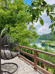 a basket on a fence with a view of a river at Apartment with river Una view / Ilma 1 in Bihać