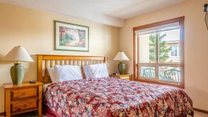 a bedroom with a bed and a window at Fireside Lodge #315 By Bear Country in Sun Peaks
