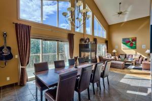 a dining room with a table and chairs and a living room at Soleil Chalet in Sun Peaks