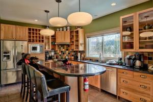 a kitchen with a large island with a glass counter top at Soleil Chalet in Sun Peaks