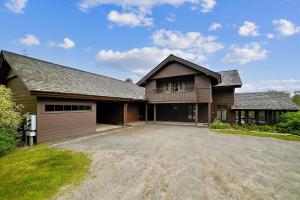 a large house with a garage and a driveway at Trapp Villa 29 in Stowe