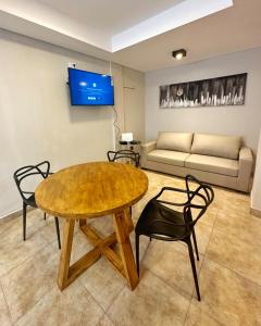 a living room with a table and chairs and a couch at Paramont Rosario 1 in Rosario de la Frontera