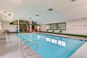 a swimming pool with blue water in a building at Village Green 8D in Stowe