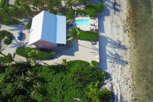 an aerial view of a building on a beach at Cayman Dream by Grand Cayman Villas & Condos in Driftwood Village