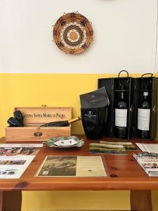 a wooden table with two bottles of wine on it at Agriturismo Graziano e Barbara in Porto Conte