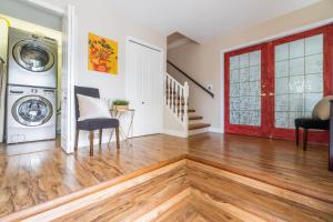 a living room with a washing machine and a red door at Lake View Hideaway in Vernon