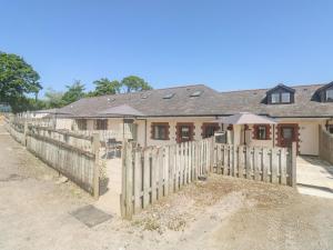 a wooden fence in front of a house at Kingfisher Cottage in North Molton