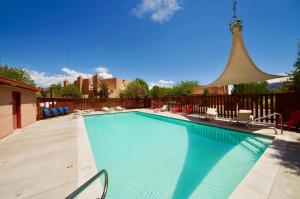 a large swimming pool with chairs and a gazebo at Sunset View #3234 in Moab