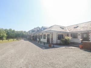 a row of houses on a gravel road at Stags Cottage in North Molton