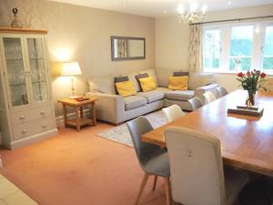 a living room with a table and a couch at Willow Brook in Glossop