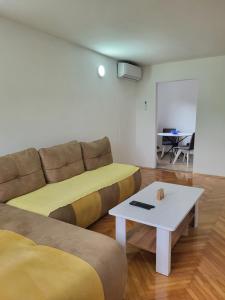 a living room with a couch and a table at Apartment Novi Central in Španjola +9 photos